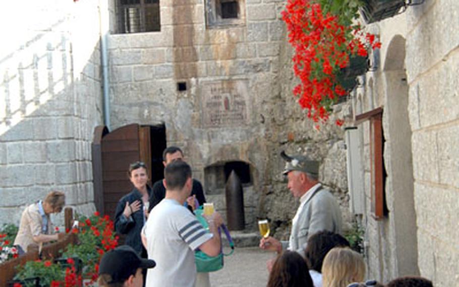 Tourists stand outside the snack bar near the casemate entrance at Forte Belvedere with guide Fabrizio Corradi.