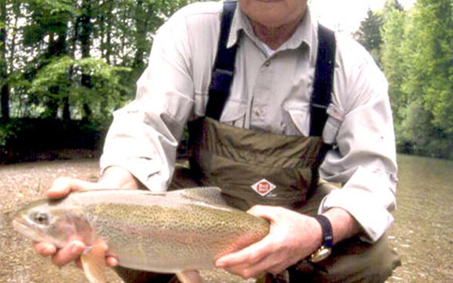 Larry Walks, a North Dakota native who nearly 30 years ago retired from the Army in Germany, shows off a big rainbow trout from the Deutsche Traun river.