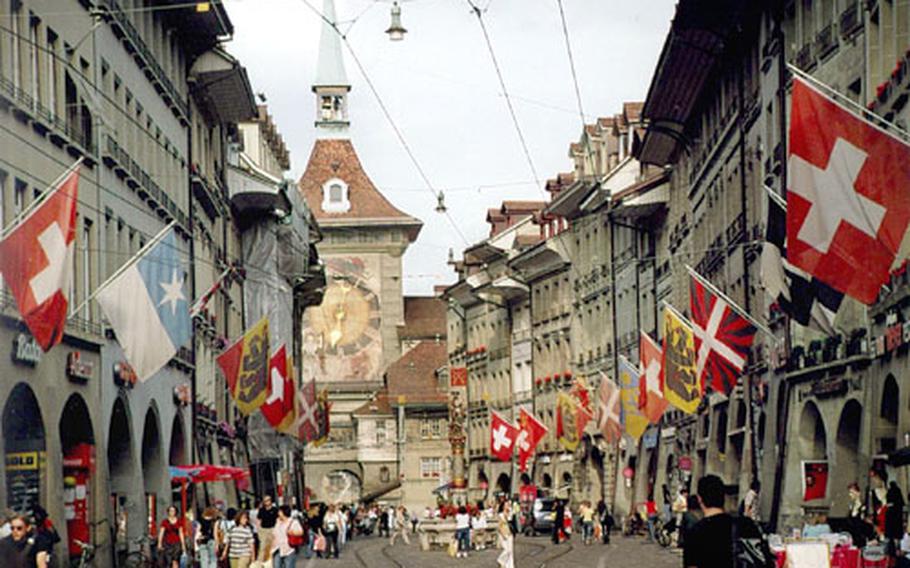 Colorful flags flutter above the arcades on the Kramgasse in the heart of Bern, adding a festive flair to the city.