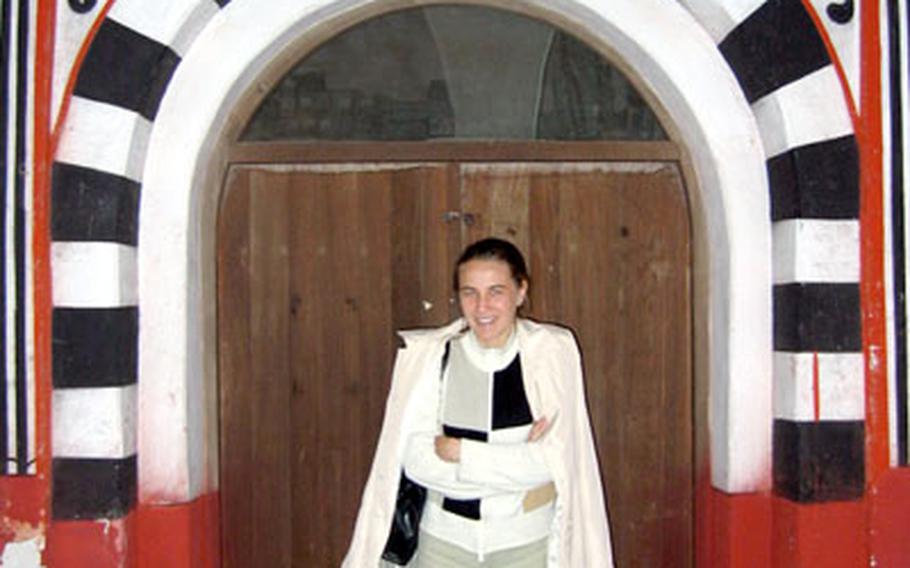 /Stars and Stripes The tour guide, Denitsa, stands framed in a doorway at the Rila Monastery. Denitsa knows all of Bulgaria like others know their own backyards.