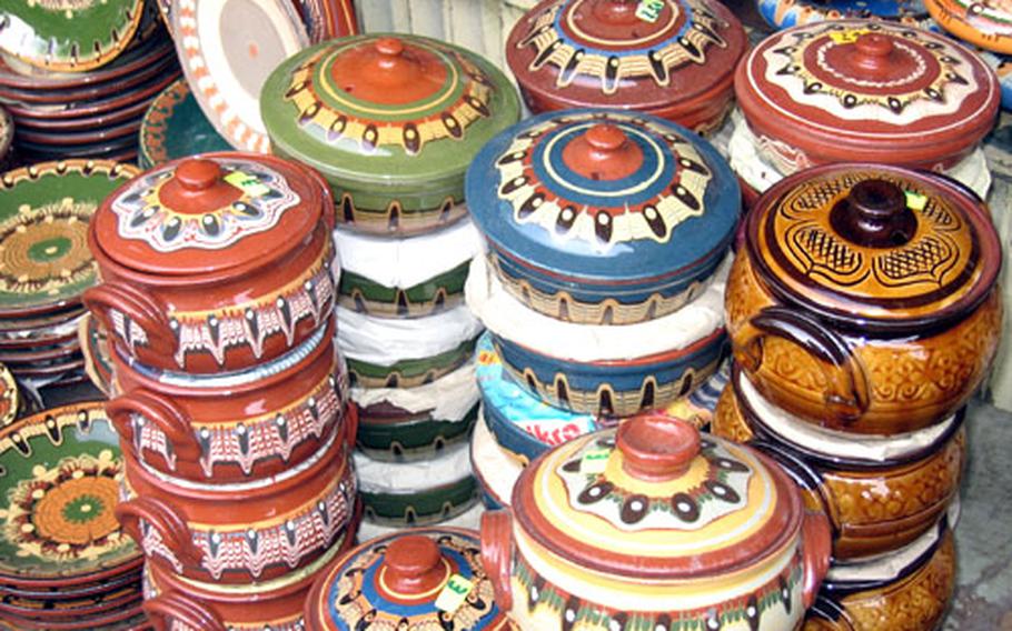 Colorful pottery, a hallmark of Bulgarian handiwork, is stacked up for sale at an open-air market in Sofia.