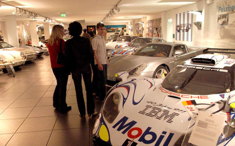 Race cars and street cars sit side by side at the museum.