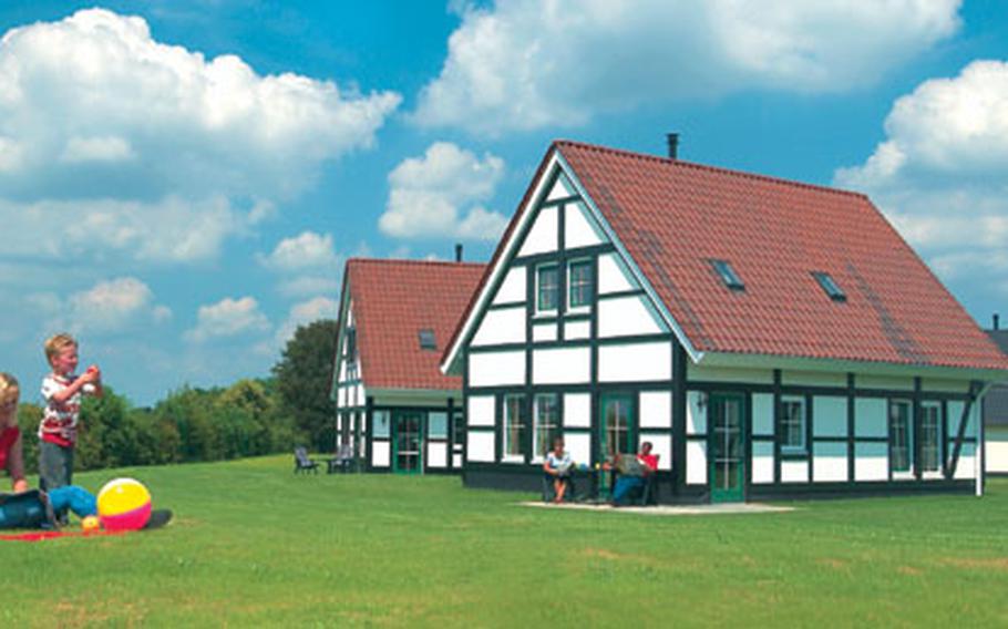 A six-person bungalow at Kasteeldomein De Cauberg in the Netherlands is surrounded by grass and open spaces to give it a rustic look. Inside are modern conveniences for those who want to prepare their own meals.