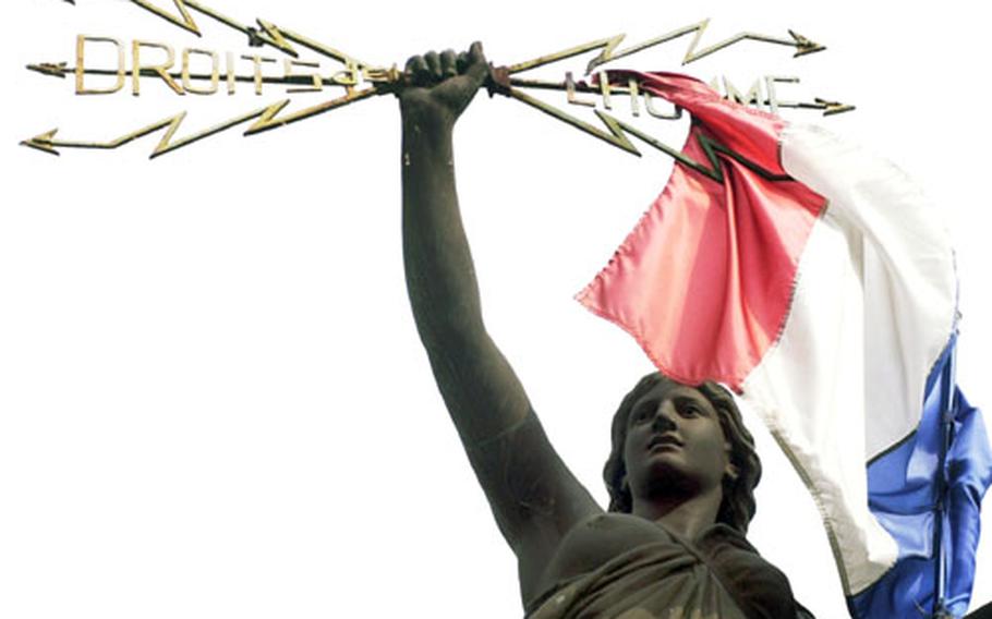 A statue of Marianne, the symbol of France, holds aloft lightning bolts with the words "Droits de l&#39;homme," or "rights of man." The statue is in the little town Pézenas, near Bezier in the Languedoc region of southwestern France.