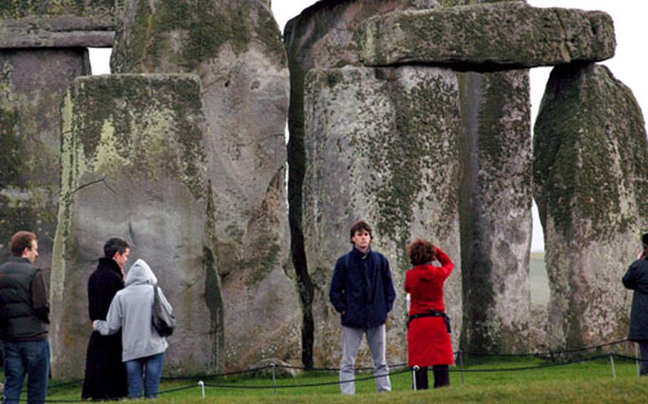 Visitors to ancient Stonehenge, built in three phases starting over 5,000 years ago, grab some photos and a close look at the massive standing stones.