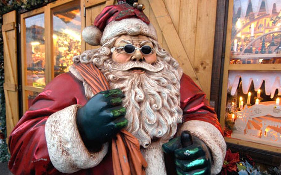 A "cool" Santa Claus in front of a stand selling Christmas decorations at the Mannheim Christmas market.