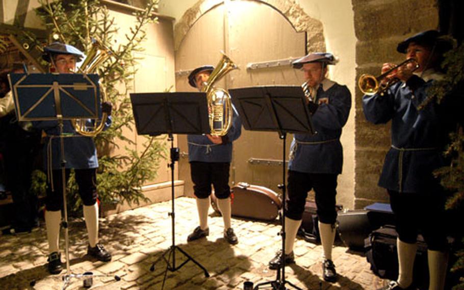 Dressed in medieval style, a quartet plays Christmas carols at the Rothenburg Christmas market.