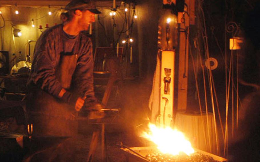 A blacksmith creates an ornament at last year’s Christmas market in the palace courtyard.