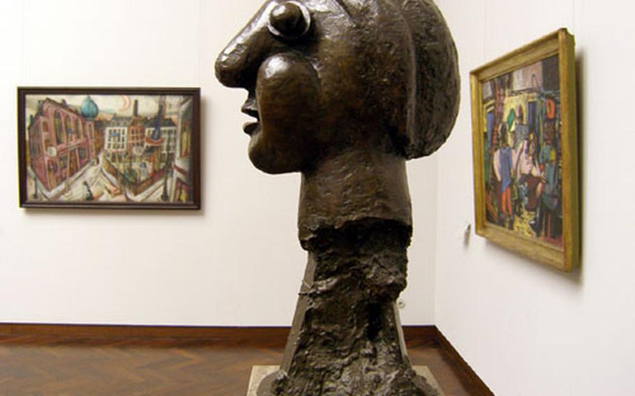 Pablo Picasso&#39;s "Woman&#39;s Head" is framed by two works by Max Beckmann in the Städel, one of the many museums along Frankfurt&#39;s Museumsufer, or museum embankment.