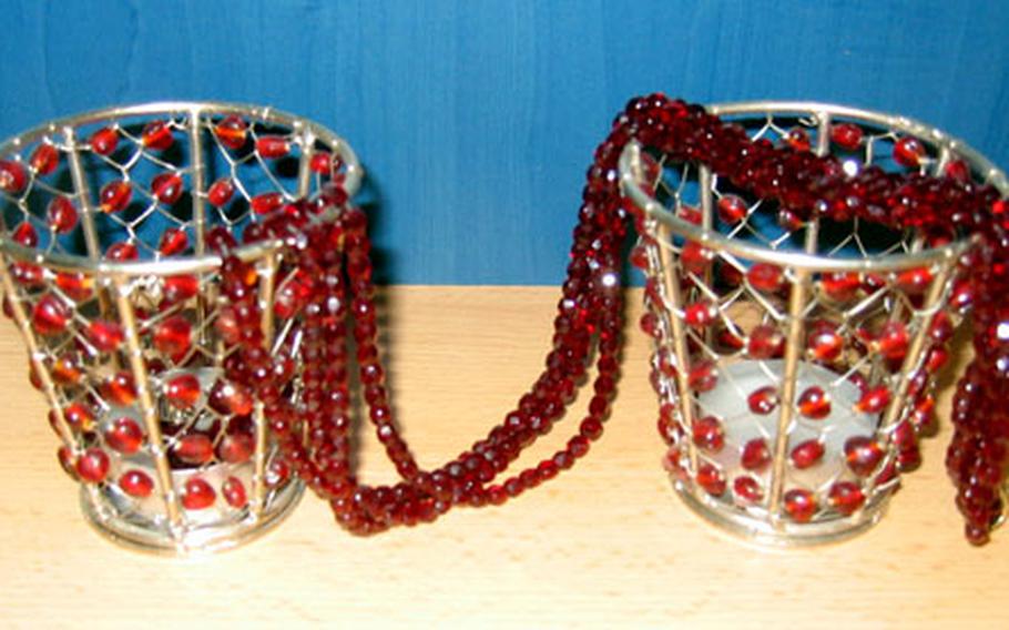 A cut-glass necklace made of four intertwined strands, received as a gift from Prague over a decade ago, has maintained its sparkle through the years. It is shown here draped over candle holders.