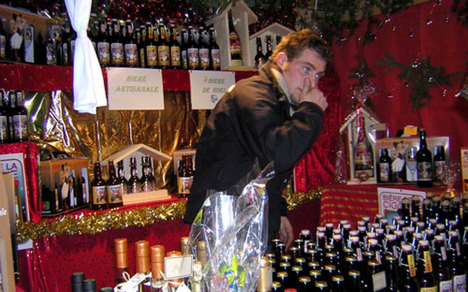 A vendor sells Alsatian Christmas beer by the bottle.