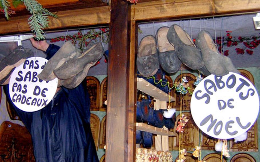 Sabots — French wooden clogs — are among the items available for sale at this woodcarvers’ stall. The sabots are traditionally used as a Christmas decoration and to hold small gifts.