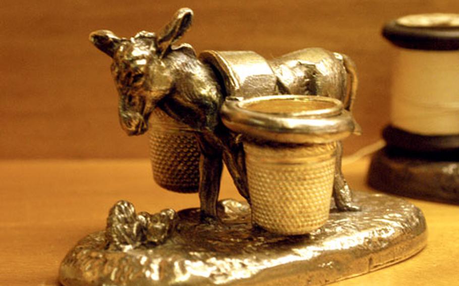 This thimble holder in the shape of a donkey holds a pair of thimbles.