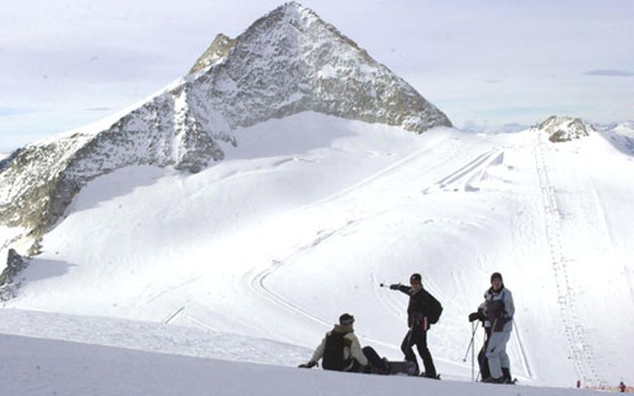 Skiers and snowboarders stop at the top of the glacier in Hintertux, Austria, in October.