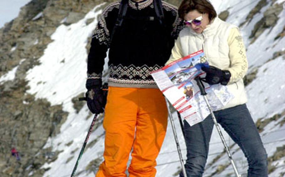 A couple consults a map of the slopes before heading down the glacier.