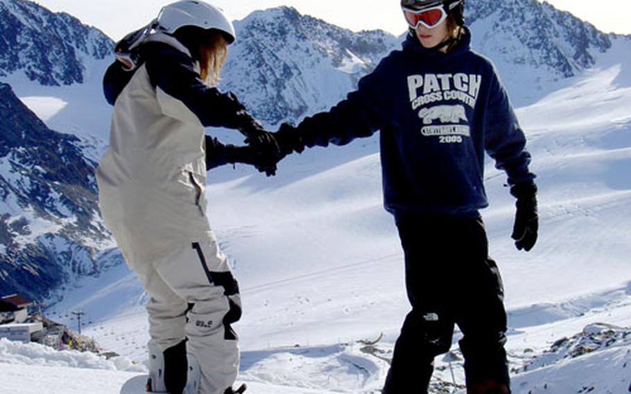 Derek Taylor, a member of the Sitzmarkers Ski Club, provides instruction to fellow member Amy Crawford, who was learning to snowboard during the club’s trip to Pitztal Glacier in Austria in November.