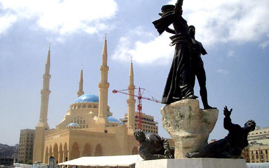 A bullet-riddled monument to the so-called martyrs of Lebanon’s Civil War stands in front of the new mosque being built in downtown Beirut.