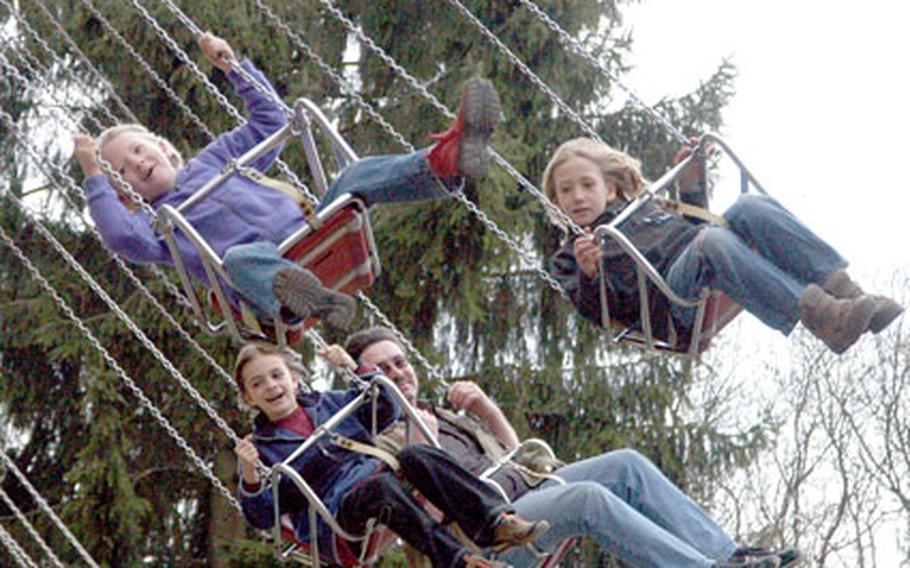 A group of riders on the “Rhein-Main Flyer” carousel swing in unison on what is, rather inexplicably, a very popular ride.