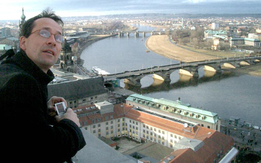 A tourist on the Frauenkirche tower looks back at the church. Entrance to the church is free, but for a few euros you can climb to the top and enjoy a panoramic view of the city. The entrance to the tower is on the outside of the church, around a corner from the main entrance.