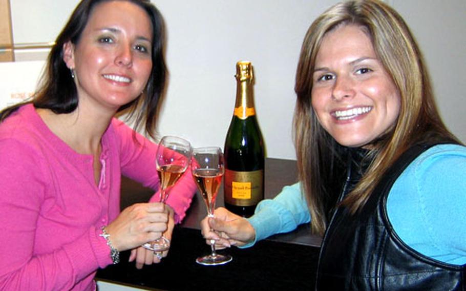 Britt Warden, left, and her sister Sarah sample champagne after taking the tour at the Veuve Clicquot Champagne house in Reims, France.