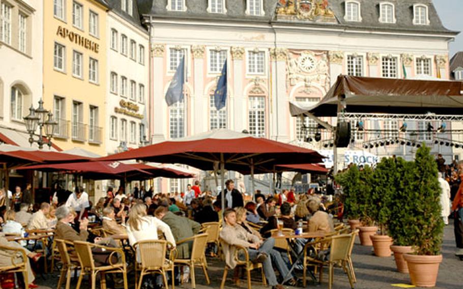 Patrons enjoy a few beers and some live music in front of the town hall in downtown Bonn, Germany. The city is known for its music and hosts open-air concerts throughout the summer.