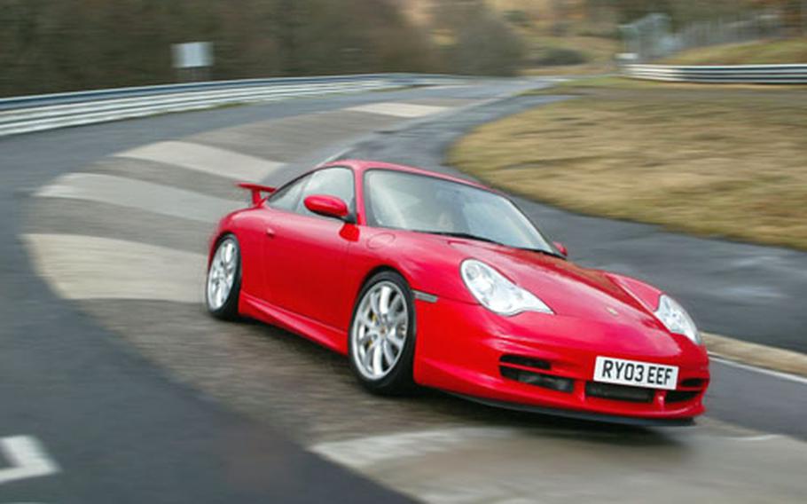 A Porsche Carrera 4 slices through a turn at Nürburgring, Germany. Anyone with a fast car and 16 euros can have a go.