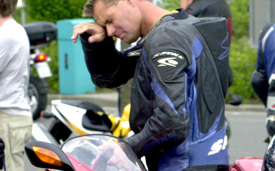 A German motorcycle racer looks fatigued after torrid laps around the long track, which has endless twists and turns, but only two straights.