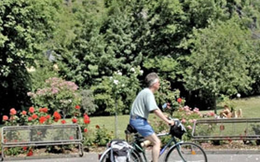 A biker makes his way along the bike path in Braubach, home to the Marksburg, one of many castles along the Rhine valley.