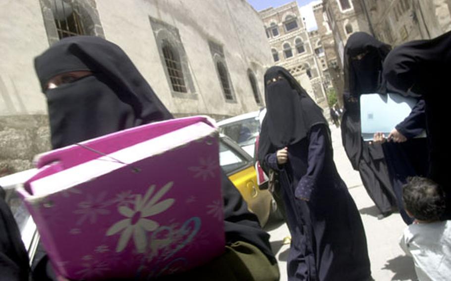 For Westerners, the sight of women wearing head and face coverings is disconcerting. Nearly all Yemeni women — though not all Muslim women working there — cover up. But it’s common to see stilleto heels and blue jeans peeking out underneath the black material.