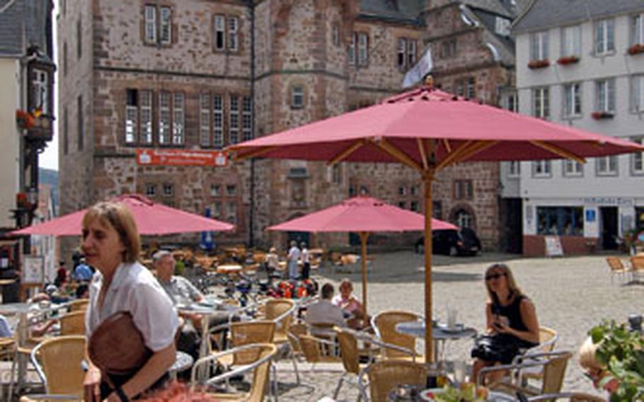 A cafe on the marketplace in Marburg, Germany, with the Rathaus, or town hall, in the background.