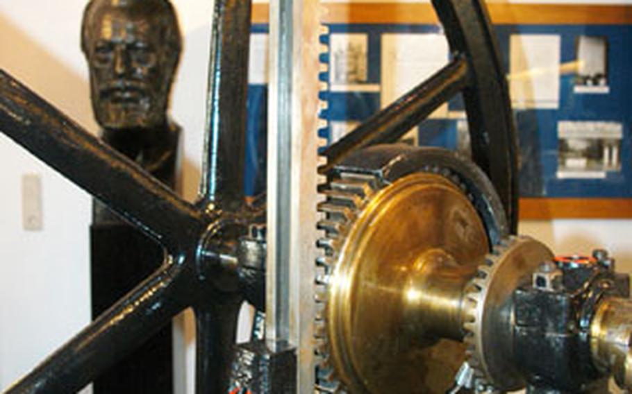 A bust of Nicolaus August Otto sits behind the first functioning motor, invented in 1861.