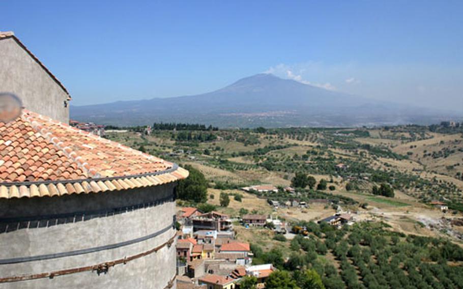 Climb to the third floor of the Norman castle in Motta Sant’Anastasia, Sicily, for breathtaking views of the surrounding valley and Mount Etna.