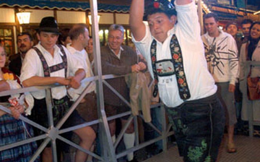 Visitors to Oktoberfest can perform feats of strength to impress onlookers.