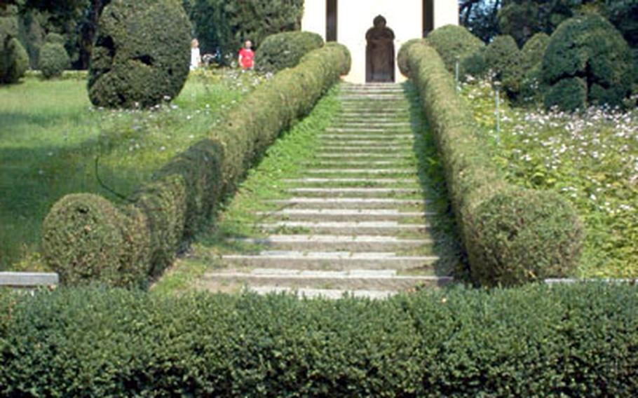 Stairs connect a series of small ponds to the Hermitage in Parco Sigurtà, a large park in Italy south of Lake Garda that mixes botanical gardens with large areas of lawn and small forests.