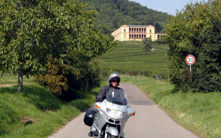 A motorcyclist zips down the road leading from the Villa Ludwigshöhe, which overlooks the vineyards of Rheinland-Pfalz.
