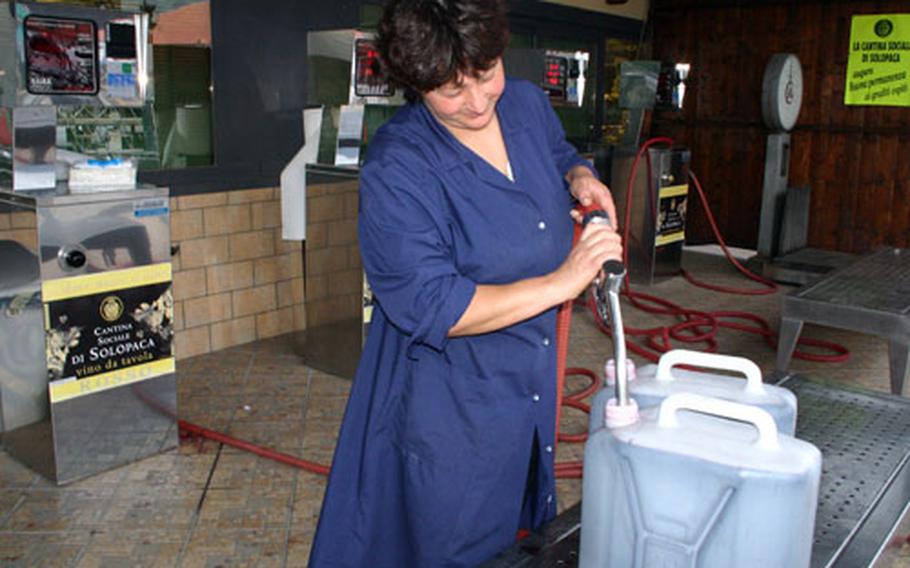 That isn’t petrol. Some Italians buy their wines by the jug, and an employee of the Cantina Sociale di Solopaca dispenses red table wine from what look like fuel pumps.