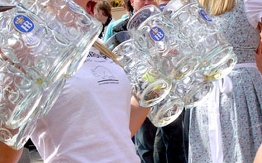 A reveler shows her beer handling skills outside the Hofbraü tent at this year’s Oktoberfest in Munich, Germany, demonstrating that it’s not too hard to hold a dozen mugs — when they’re empty. More than 6 million people visit the world’s most famous beer fest annually. This year’s Oktoberfest ends Tuesday.