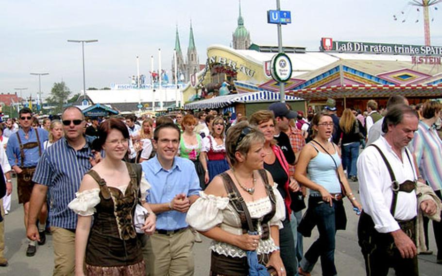 Patrons, some dressed in Bavarian finery, wander between beer tents looking to claim a seat on the opening day of this year’s Oktoberfest.