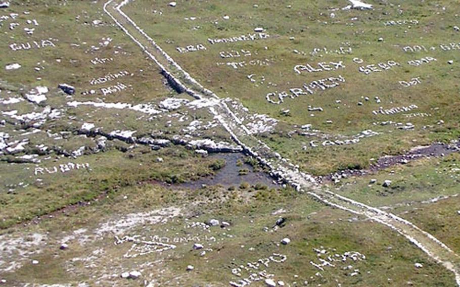 Just like graffiti artists with paint, wilderness trekkers leave their names and messages behind them. Some walkers used white stones to write messages and their names along a marked trail.