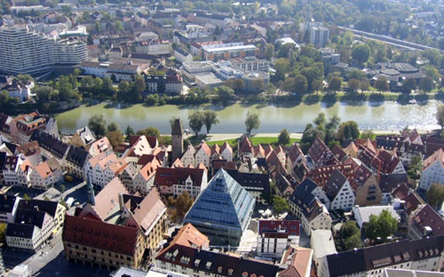 The view from the top of the Ulm Münster&#39;s steeple shows the town below, the Danube River, and the blue, pyramid top of the Ulm&#39;s new municipal library, which opened in 2004. It was built near the historic town hall on Market Square.