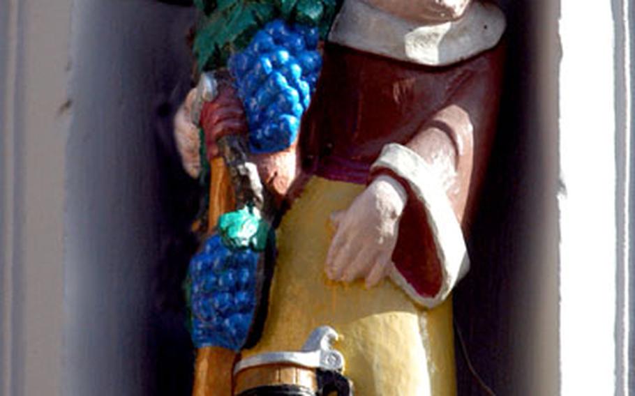 A statue of a winemaking monk decorates a local wine tavern in Freinsheim.