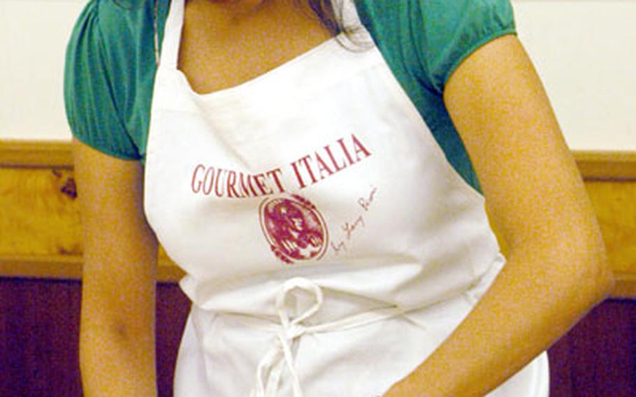 In a Gourmet Italia class, Lisa Williams learns to cut fresh pasta dough that will be used to make tortellini and ravioli.
