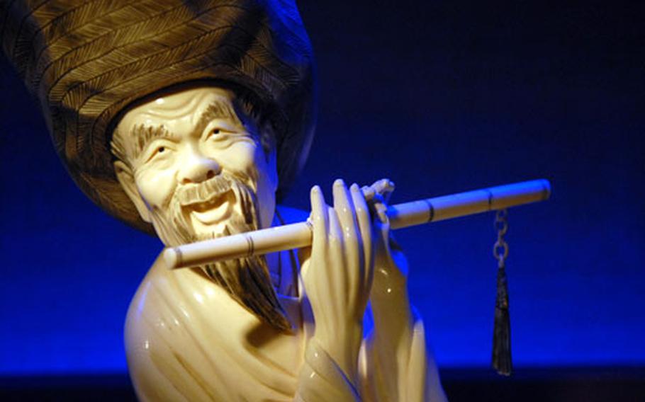 A Chinese figure playing the flute from around 1900 is one of many pieces of ivory artworks at the German Ivory Museum in Erbach, Germany.