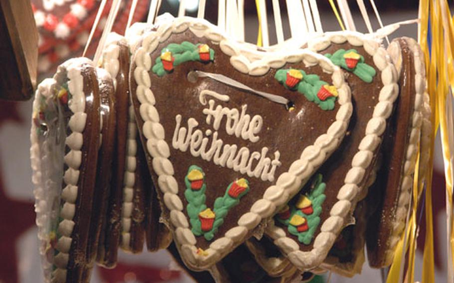 A gingerbread heart wishes you a merry Christmas.