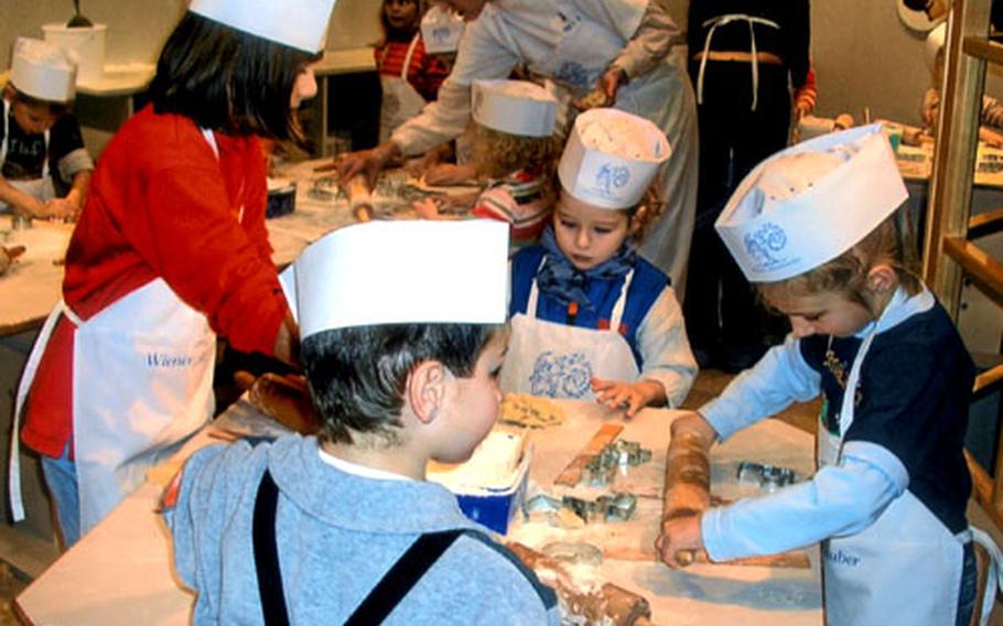 Children enjoy making traditional Christmas cookies at the Christkindlmarkt at Vienna’s Rathaus, or city hall. Christmas shoppers can buy a bag of buttery crescents hot from the oven for about 2 euros at the market.