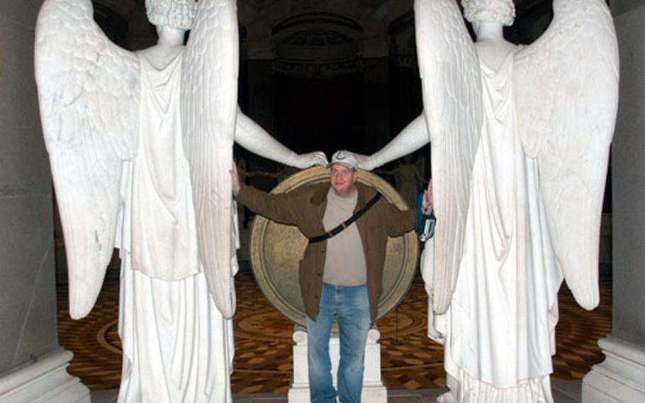 Tom Mulkern, an American who works at Mainz-Kastel, Germany, poses for a photograph to show the dimensions of the marble maidens surrounding the rotunda of the Befreiungshalle, or Liberation Hall.