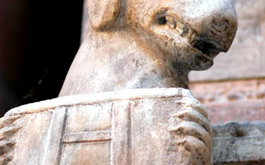 A dog bearing a shield with a ladder insignia guards one of the elaborate tombs at the eastern end of the Piazza Dei Signori in Verona.