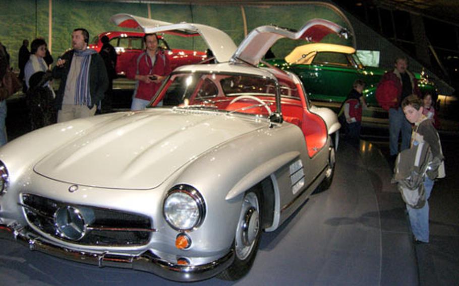 The 1955 300 SL Coupe draws the admiration of a young fan at the Mercedes-Benz Museum in Stuttgart, Germany.