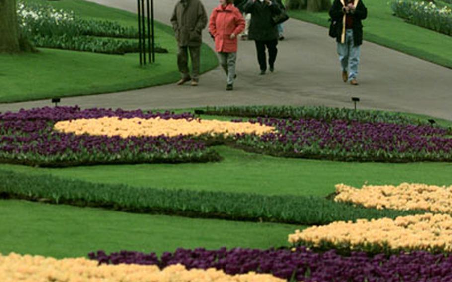 Visitors walk through the gardens at Keukenhof, on the outskirts of Lisse, the Netherlands.