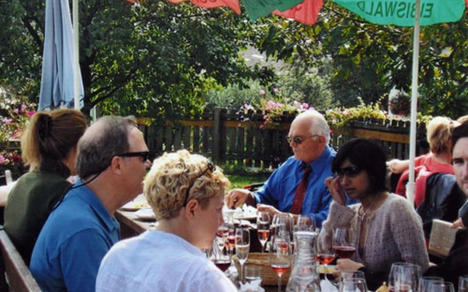 Guests sit down to sample Styrian wine and plates of locally produced meats, cheeses, patés, spreads, and home-baked bread at the Weingut Langmann, a traditional "Buschenschänken, " or wine tavern.